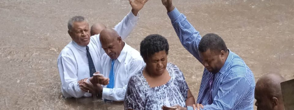 Some of the people baptized in Fiji on March 4. The baptismal ceremony took place under heavy rains. [Photo: Adventist Record]