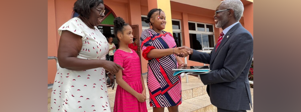 Adrian Cotterell (right), possibility ministries coordinator of the Seventh-day Adventist Church in Jamaica, presents a laptop computer to 18-year-old Emily Johnson, a student of the Lister Mair Gilby High School for the Deaf. [Photo: Nigel Coke]