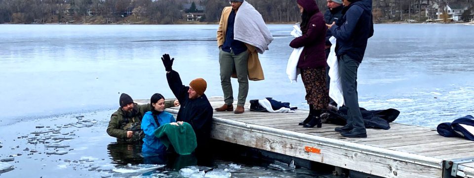 Jared Little (with hand raised) baptizes Allison McDonald in a lake in Shoreview, Minnesota, United States, November 23, 2023. [Photo: The Way Seventh-day Adventist Church]