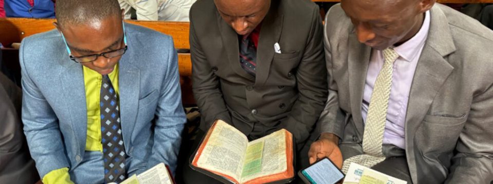 Enock Ntunzwenimana (left), president of the Burundi Union Mission of the Seventh-day Adventist Church, with two fellow leaders learning Discovery Bible Reading. [Photo: South Pacific Division]