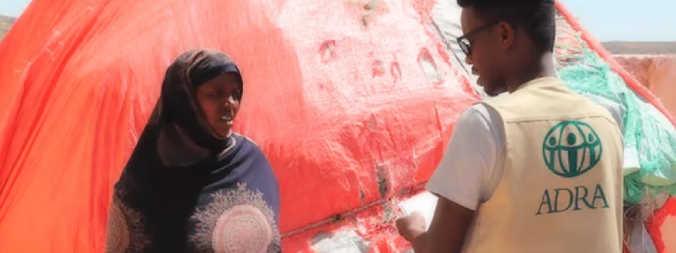 A villager talks to an ADRA employee in Somalia. [Photo: © ADRA Somalia]