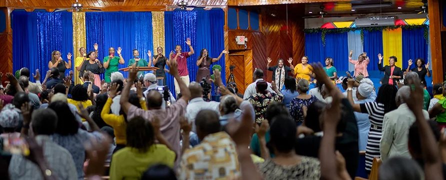 New believers, seasoned members, and church leaders sing and praise together during a special celebration program on April 13, which marked the end of the weeks-long evangelistic efforts in St. Croix that resulted in a historic 105 baptisms. [Photo: Curtis Henry]