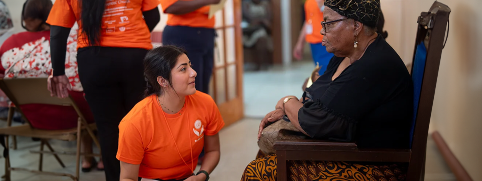 Tiffany Carbajal (left), nursing student at Loma Linda University, talks to a patient in triage on April 12, on the premises of the Central Adventist church in Frederiksted, St. Croix, US Virgin Islands. [Photo: Curtis Henry]