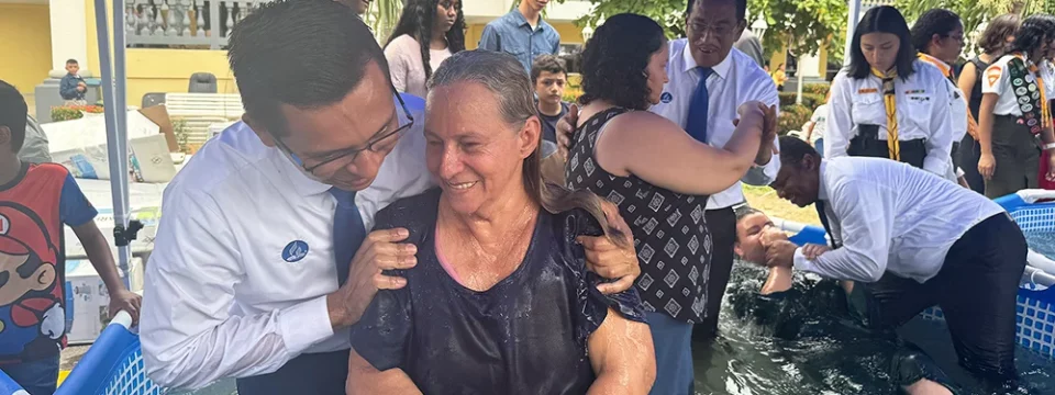 A new believer smiles as she is hugged by a Seventh-day Adventist pastor who baptized her during the All the Family in Mission celebration in San Pedro Sula, Honduras, April 20. [Photo: Libna Stevens/IAD]